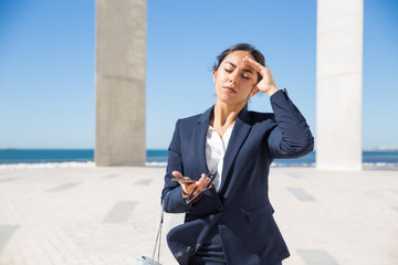 Frustrated business lady suffering from heat