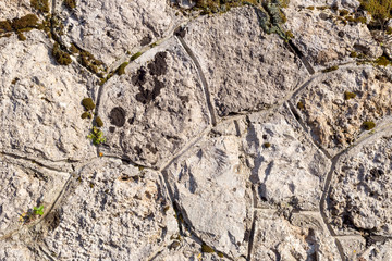 The background old gray stony wall