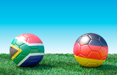 Two soccer balls in flags colors on green grass. South Africa and Germany. 3d image