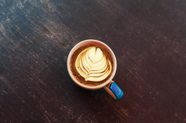  Morning coffee has a leaf on the glass made from whipped cream.