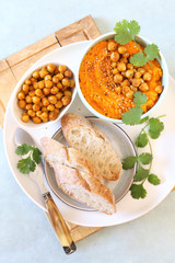 Vegetarian appetizer. Carrot and hummus dip and bread, sesame and chick-pea dressing