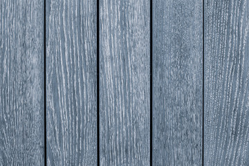 Light gray wooden table close-up. Light blue wooden painted fence. Grey wood board texture...