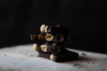 broken pieces of black chocolate with nuts