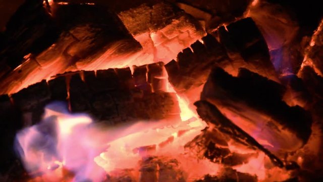 Fire at fireplace in night. Under stars and moon. Dark night and warm fire with friends.
