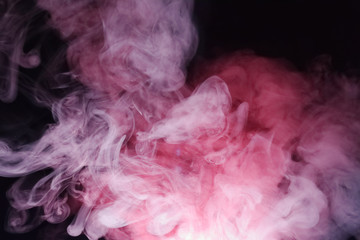 Bright colored smoke rises on a black background.