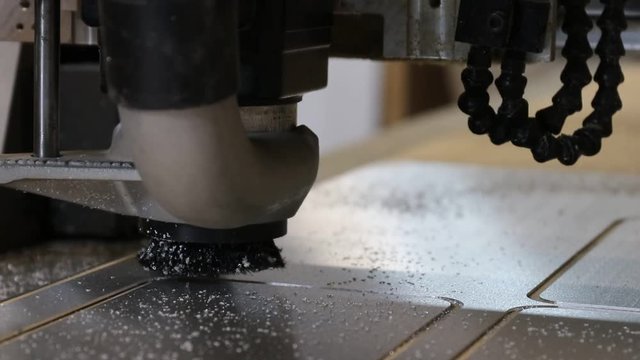 Router cutting out metal signs for restaurant