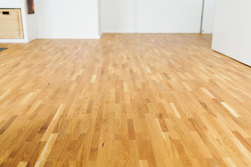 Light colored hardwood floor in a spacious room