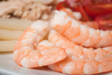 closeup of fresh shrimps with vegetables in a plate