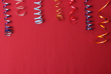  Festive background of ribbons and confetti on a colored background top view.