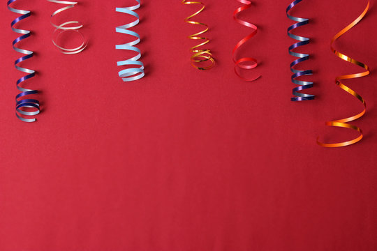  Festive background of ribbons and confetti on a colored background top view.