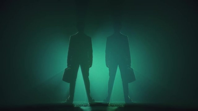 Identical Businessman With Suitcases on a Teal Background. The Concept of Option. Copy Space.