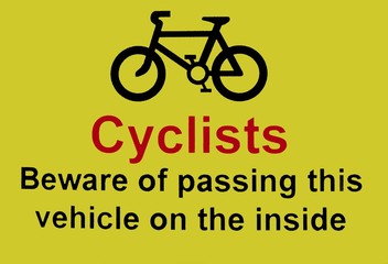 Cyclists beware of passing the vehicle on the inside sign