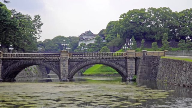 Pan left from walkway to the Seimon Ishibashi  stone bridge leading to the main gate of the  Imperial Palace, Toyko, Japan
