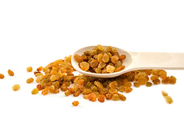 yellow raisin and wooden spoon on a white background