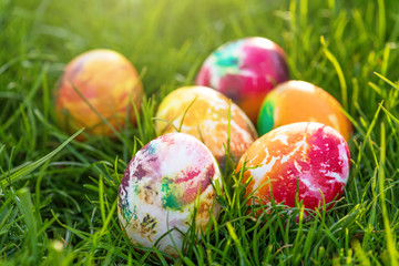 Traditionally painted Easter eggs hidden in grass.