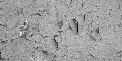 Old cracked paint on the concrete wall. Peeling paint on wall texture. Pattern of rustic blue grunge material