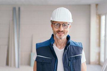 Older man wearing a hardhat and glasses