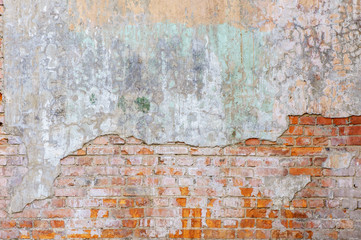 Industrial background, empty grunge urban street with warehouse brick wall. Background of old vintage dirty brick wall with peeling plaster, texture