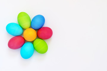 Fototapeta na wymiar Dyed easter eggs flower on white background with copy space