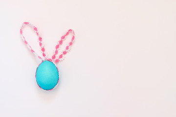 Blue easter egg rabbit with ears on white background and copy space - 259546277