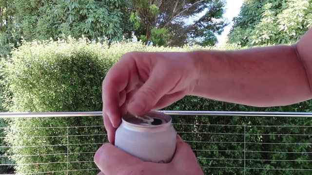 Opening a cold can of beer