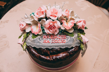 Wedding loaf decorated with greenery. the inscription on the napkin 