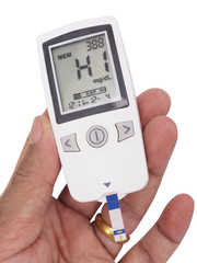 medicine, diabetes, glycemia, health care and people concept - close up of checking blood sugar level by glucometer and test stripe at home show data at HIGH blood sugar level