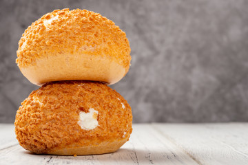 two pieces sweet puffs on a white wood table