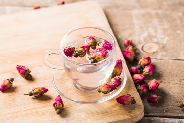Herb tea with tea rose petals. Dry rose buds, tea cup