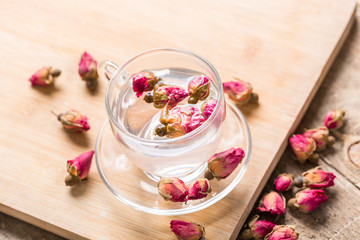 Obraz na płótnie Canvas Herb tea with tea rose petals. Dry rose buds, tea cup