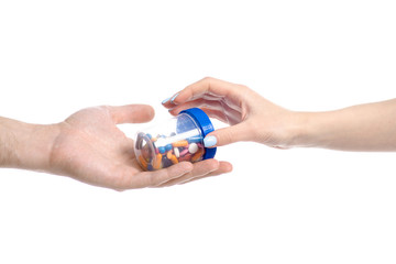 hand give jar pills to hand on white background isolation, medicine pharmacy concept