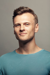 Fabulous at any age. Portrait of smiling proud 30-year-old man standing over light gray background. Close up. Classic poster, vintage style. Studio shot