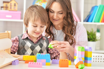 Woman and boy playing blocks game