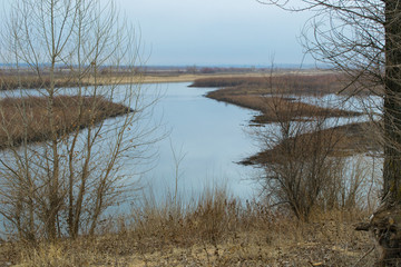 Beautiful Spring landscape. River freed from ice. Forest on the river Bank.