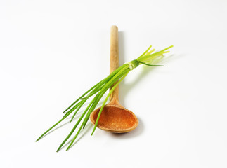 Chives and a wooden spoon