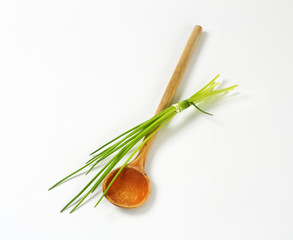 Chives and a wooden spoon