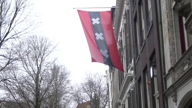 Amsterdam official city flag in historic downtown, TRACKING SHOT.