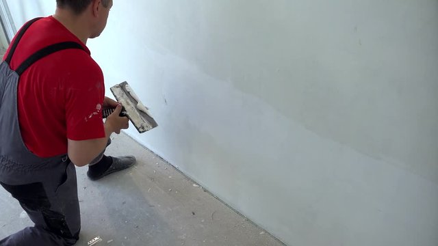 Amateur man do construction finishing works in his house. Do it yourself