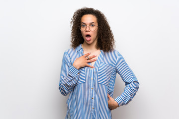 Dominican woman with striped shirt surprised and shocked while looking right