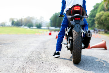 back image of a street bike racer with with soft-focus and over light in the background