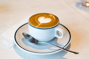 Takadanobaba, Japan, 03/23/2019 , Macchiato coffee, with a heart decoration on top with the creamy silky milk, on an italian restaurant.