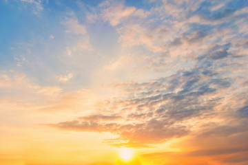 Fototapeta premium Sky blue and orange light of the sun through the clouds in the sky