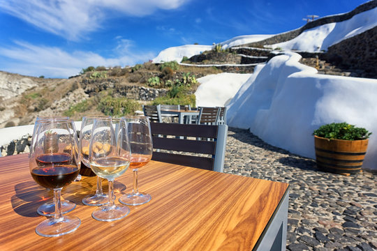 Glasses Of Wine In A Terrace, Santorini, Greece.