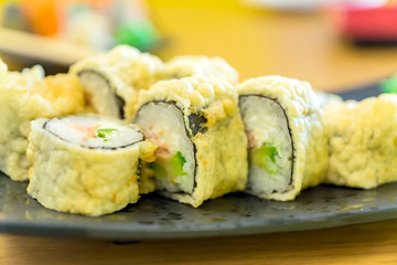 Hot fried Sushi Roll with salmon, eel, calf caviar and cheese. Japanese food.
