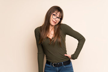 Young woman on ocher background smiling