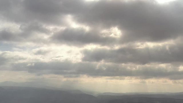 Heavenly rays of sun through the cloudy sky 4K drone video
