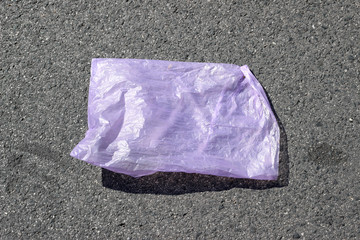 Plastic bag violet empty asphalt sidewalk pavement