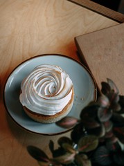 white cream cake wooden background