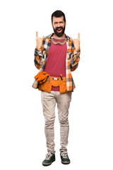 Craftsmen man making rock gesture over isolated white background