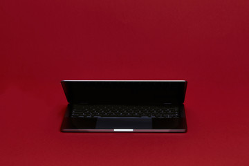 Reflective Laptop Computer on a Red Background